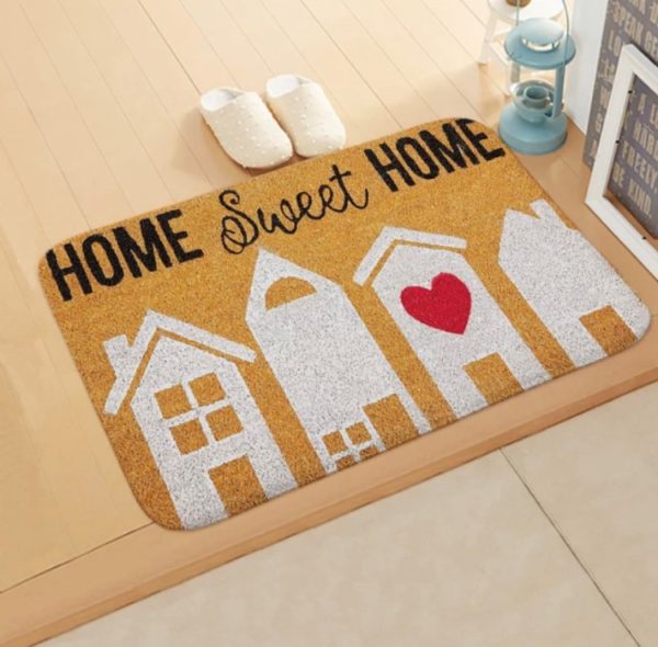 Paillasson beige marron kraft avec des maisons blanches et un coeur qi dit "Home sweet home" en noir.