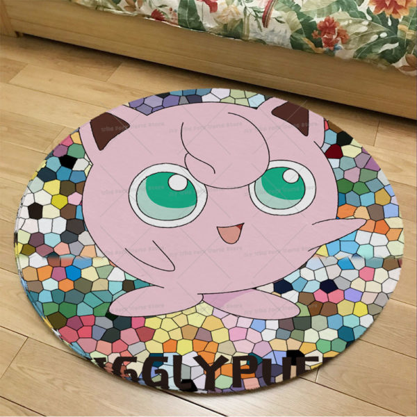 Paillasson circulaire avec Rondoudou au centre. En fond, parquet marron clair et bordure de lit.